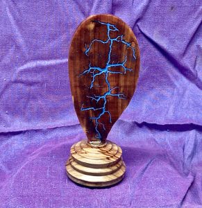 Lichtenberg burn on red cedar with blue metallic inlay on ambrosia maple base